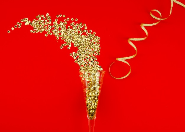 Free Photo champagne glass and gold glitter