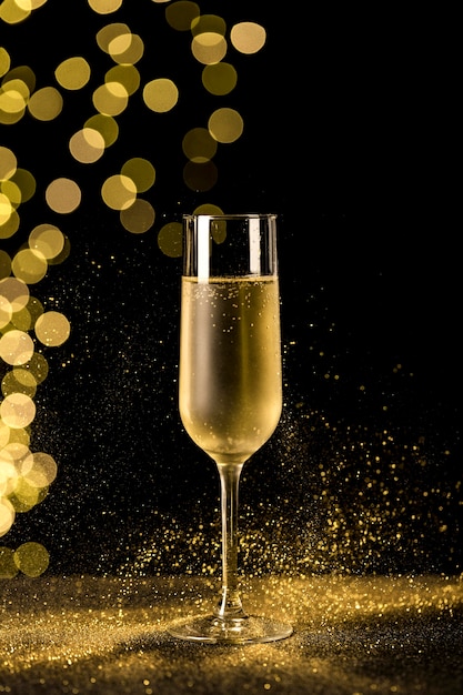 Free photo champagne glass with bokeh lights