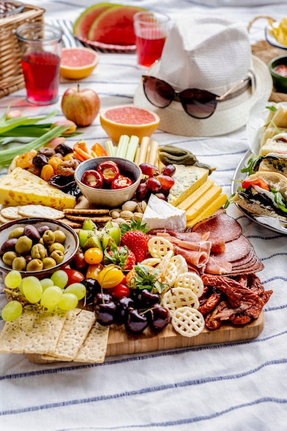 Free photo charcuterie board with cold cuts, fresh fruits and cheese, summer picnic