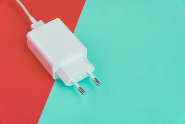 Free photo charger and usb cable type c over pink and blue background