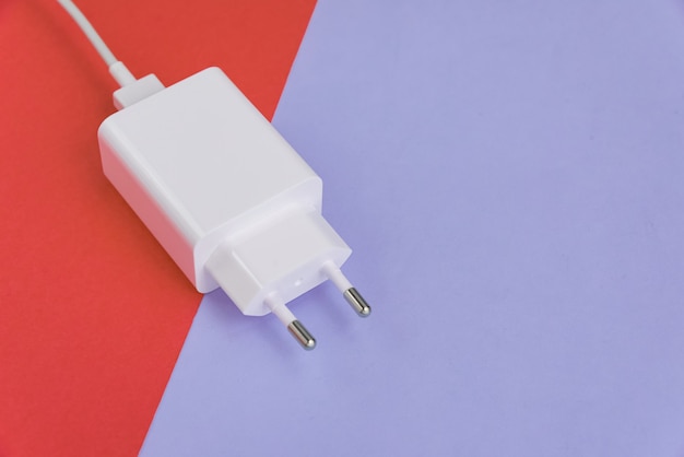 Free photo charger and usb cable type c over pink and blue background