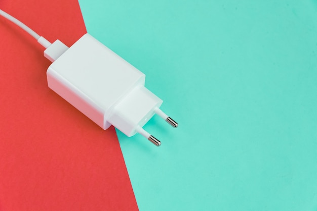 Free photo charger and usb cable type c over pink and blue background