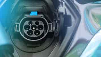 Free photo charging socket of an electric car with blue light