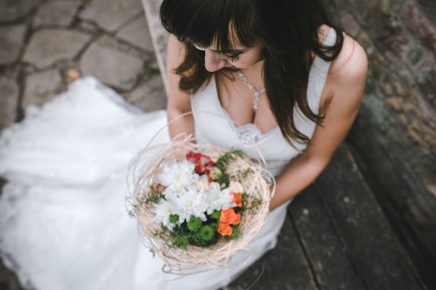 Free photo charming bride with bouquet from above