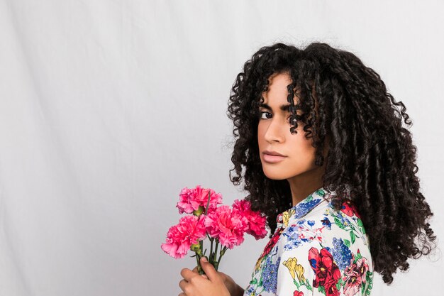 Free photo charming ethnic woman with flowers