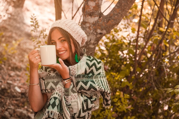 Charming female with mug in forest