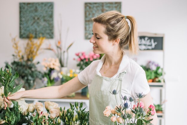 Charming florist making bouquet