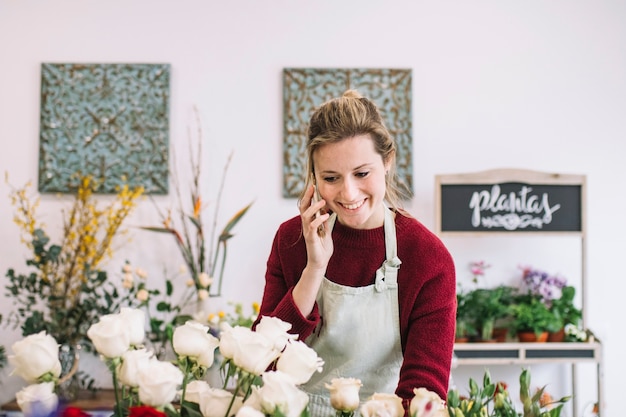 Free Photo charming florist talking on smartphone