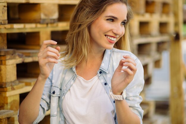 Charming girl standing near pallets