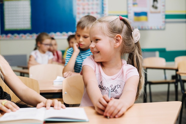 Free Photo charming girl with classmate in school