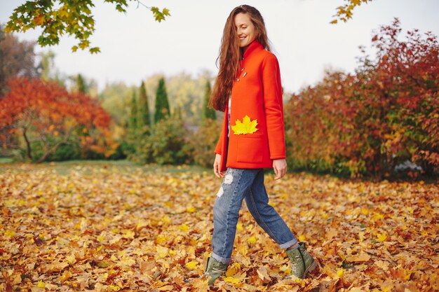 Charming girl with long wavy hair walking happy