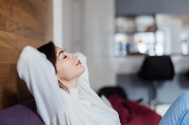 Free photo charming is dreaming on sofa at home after classes