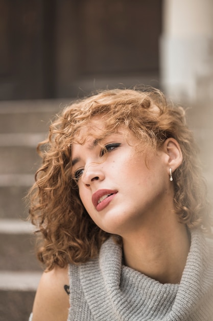 Charming lady with short curly hair 