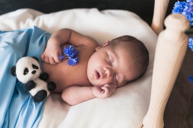 Free photo charming little baby in bed