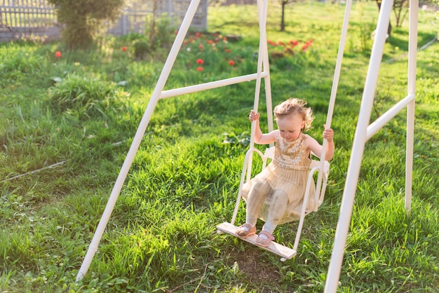 Charming little girl laughs playing on the field