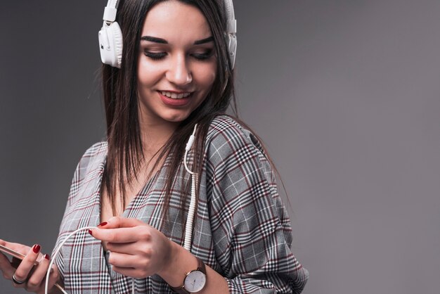 Charming woman enjoying music]