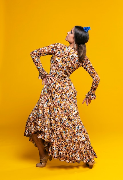 Charming woman posing with orange background