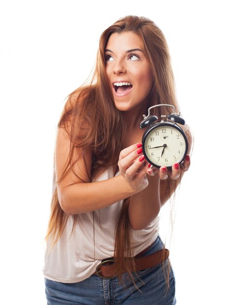 Free photo charming woman with alarm clock in hands