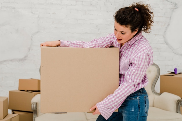 Free photo charming woman with carton box