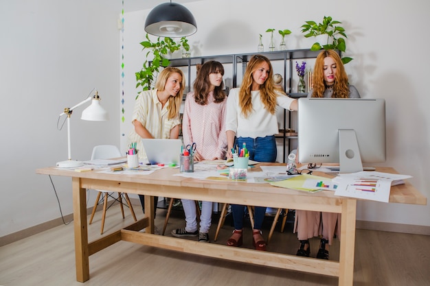 Free photo charming women posing in office