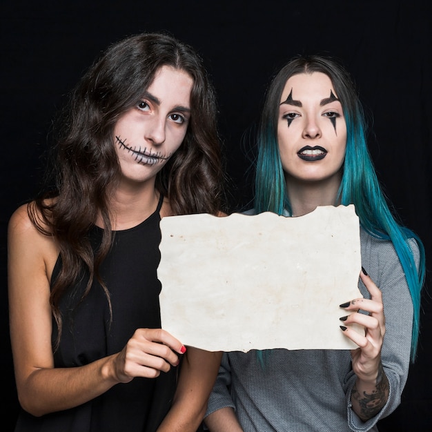 Charming young women with paper sheet