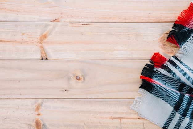 Free Photo checkered scarf on wood board 