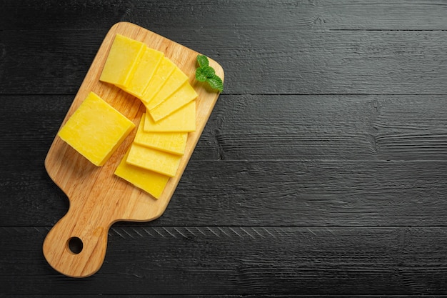 Cheddar Cheese on dark wooden surface