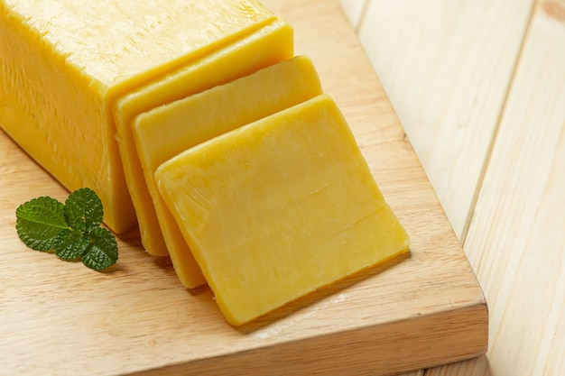 Cheddar cheese on wooden surface