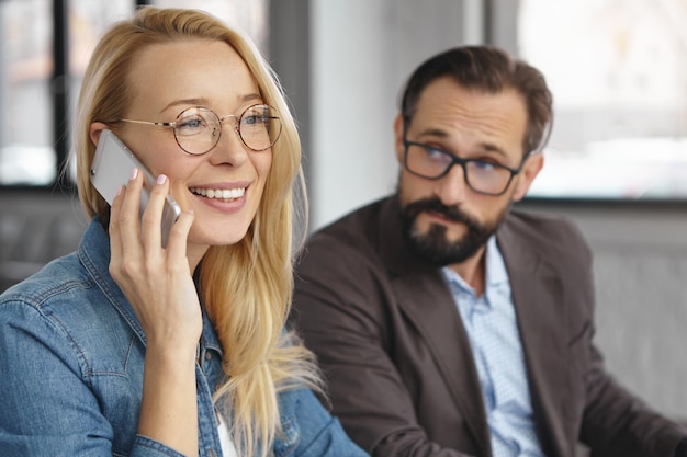 Free Photo cheerful blonde attractive woman makes business call