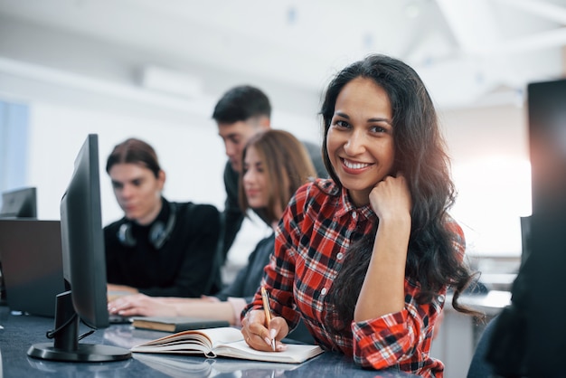 Free Photo cheerful brunette. group of young people in casual clothes working in the modern office