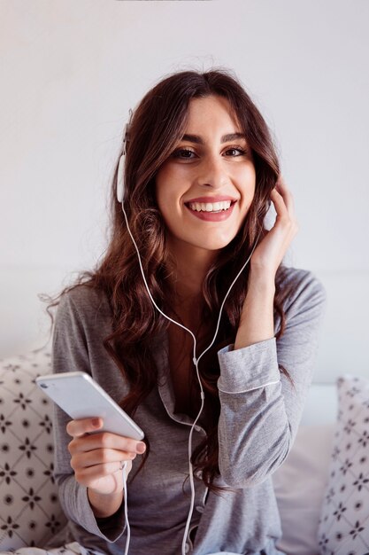 Cheerful brunette listening to music