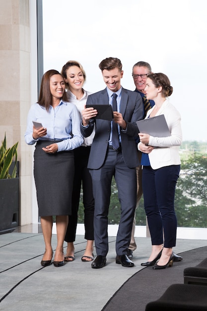 Cheerful Business People Looking at Digital Tablet