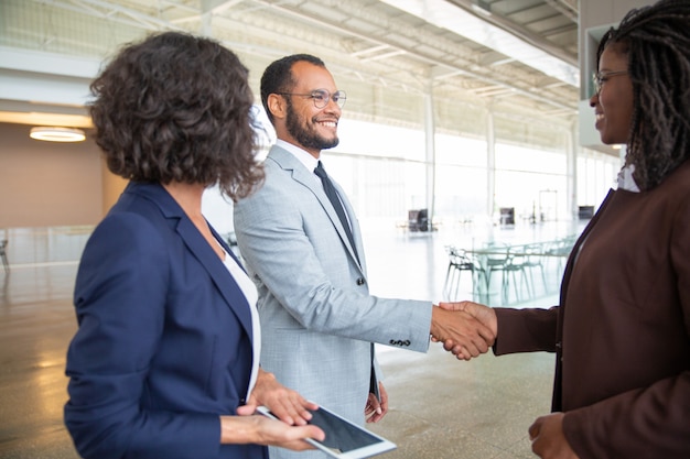 Cheerful business people shaking hands