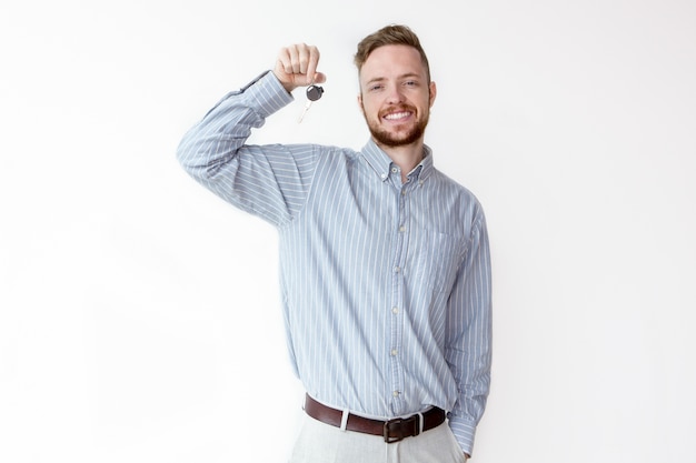 Cheerful businessman giving car or apartment key