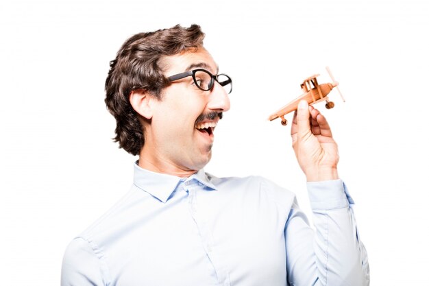 Cheerful businessman playing with his plane