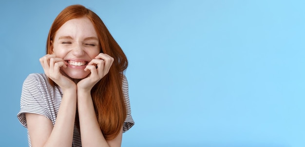 Cheerful carefree giggling ginger girl look happy bright close eyes smiling delighted hold hands