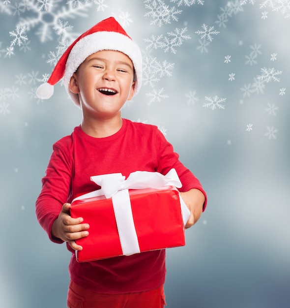 Cheerful child lifting his heavy gift