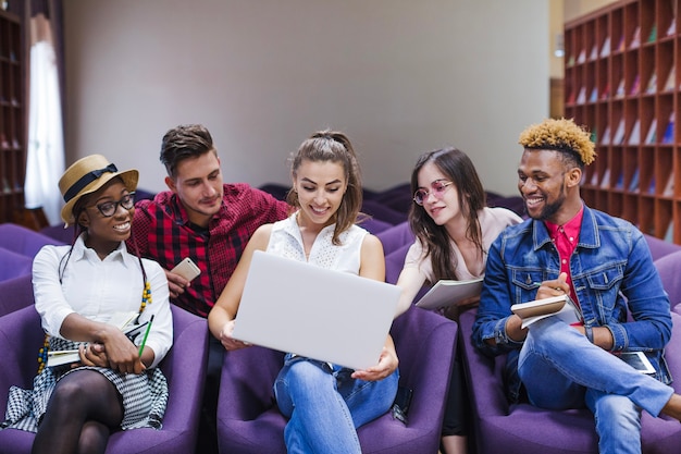 Free photo cheerful classmates watching tablet