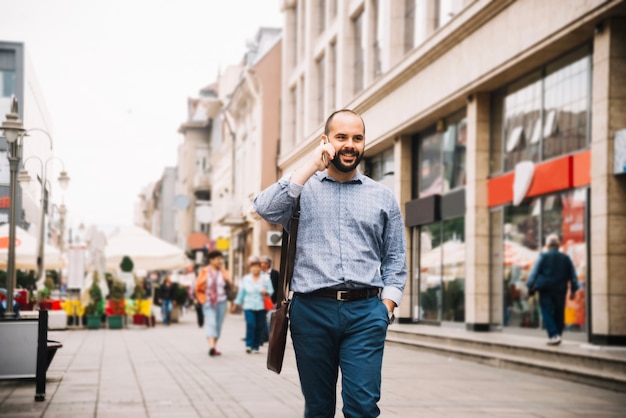 Free photo cheerful confident man talking on phone