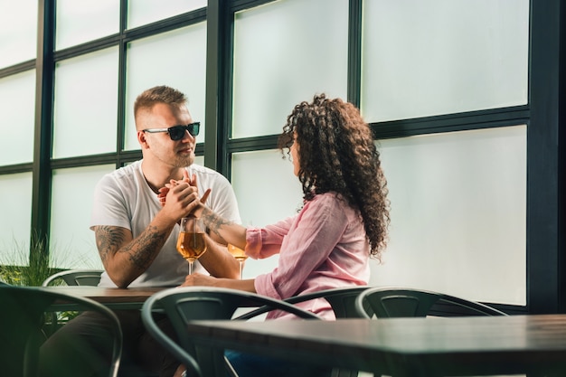 Free photo cheerful couple in cafe having a good time