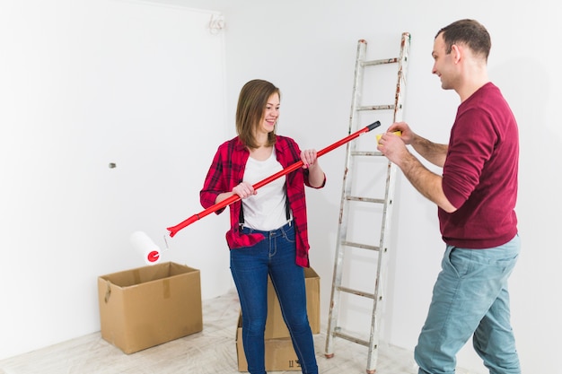 Cheerful couple doing renovation