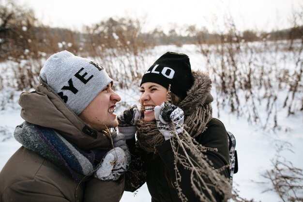 Free photo cheerful couple fooling around and hamming to each other. winter cold day.