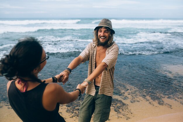 Cheerful couple playing on the beach