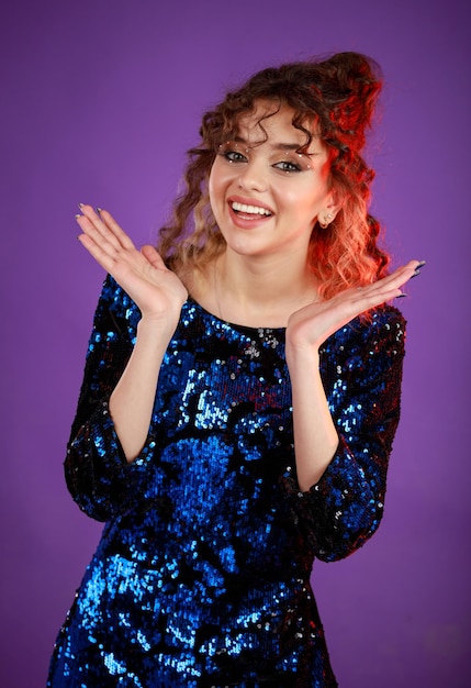 Cheerful curlyhaired girl opened her hands and feeling happy High quality photo