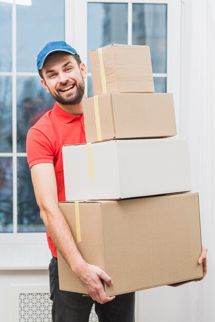 Cheerful delivery man with parcels