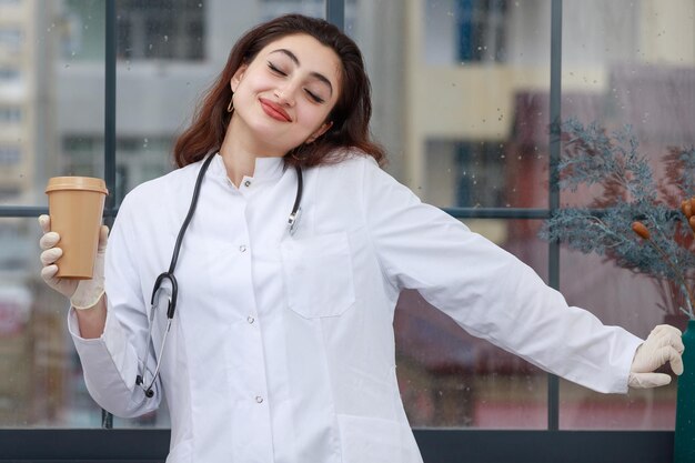 Cheerful doctor enjoying from her coffee brake High quality photo