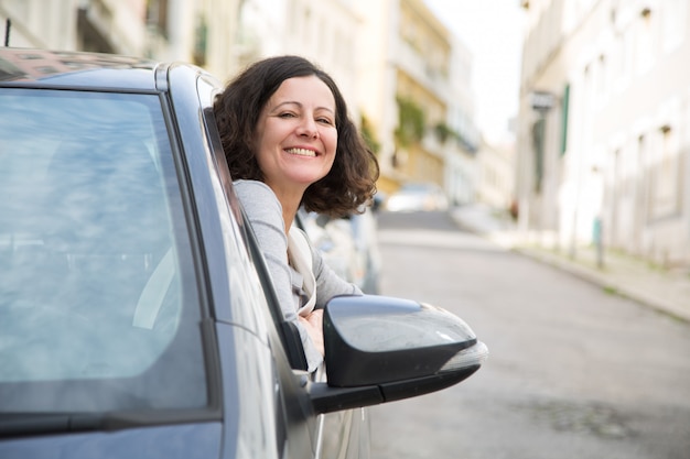 Free photo cheerful driving school student successfully passing exam