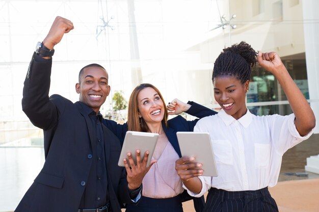 Cheerful ecstatic multi-ethnic colleagues dancing