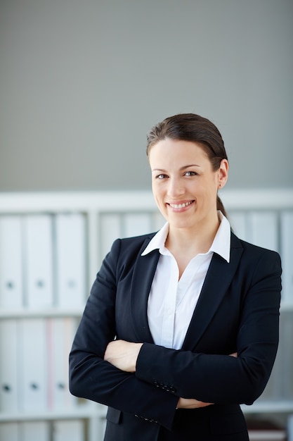 Cheerful employee with crossed arms