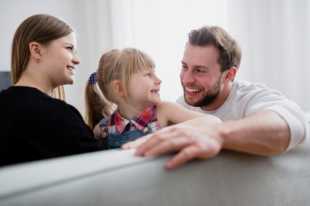 Free photo cheerful family sitting on couch